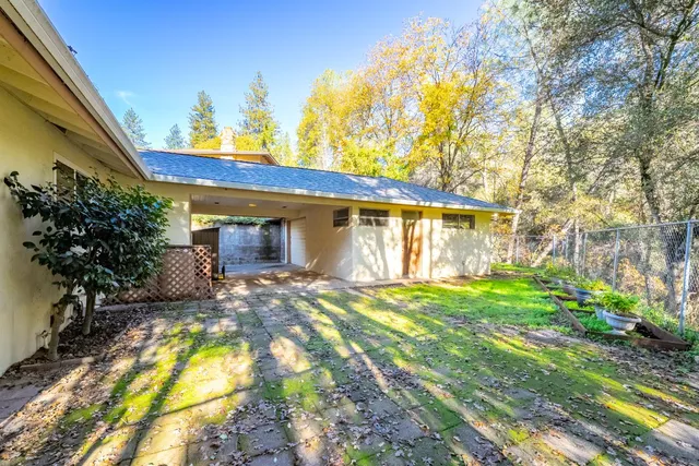 a view of a house with backyard and sitting area