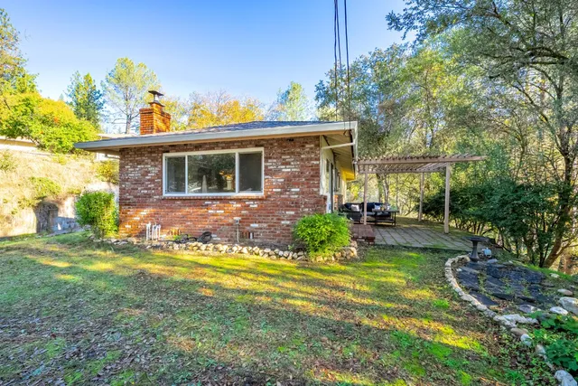a front view of a house with yard and green space