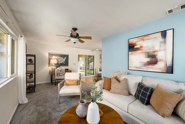 a living room with furniture and a large window