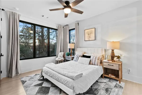 a bedroom with a large bed and a window