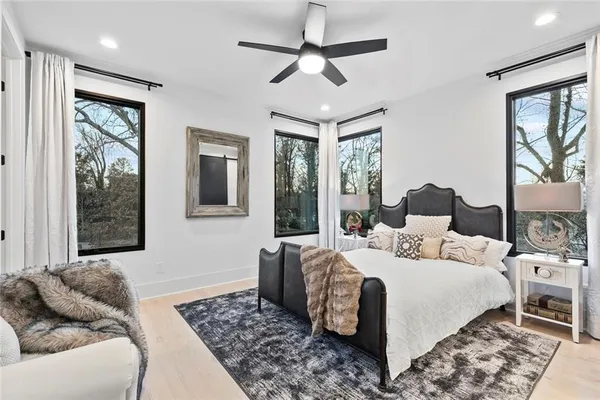 a bedroom with a large bed and a chandelier