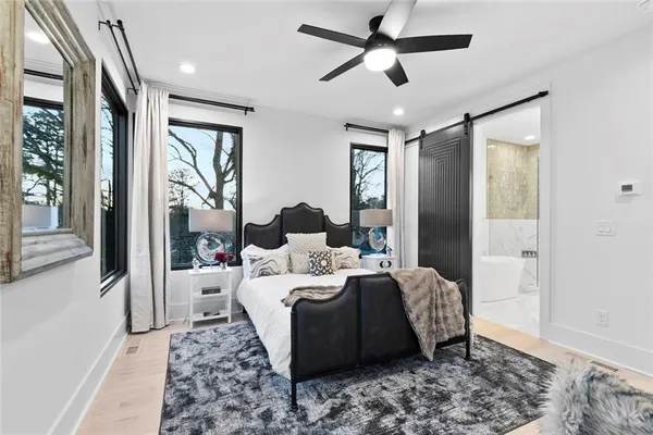 a bedroom with a bed and ceiling fan