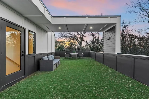 a backyard of a house with table and chairs