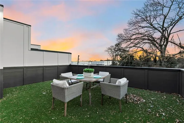 a view of a chair and table in the backyard