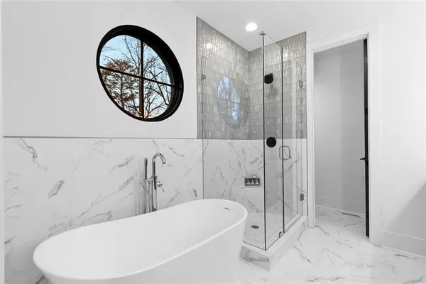 a bathroom with a bathtub and a shower