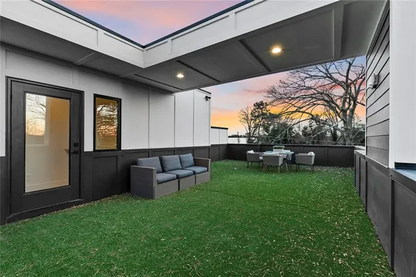 a backyard of a house with table and chairs