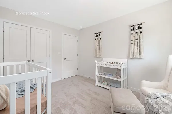 a bedroom with a bed and a white cabinet