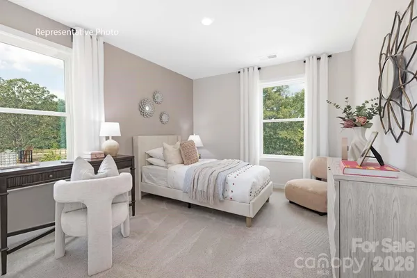 a bedroom with bed and a large window