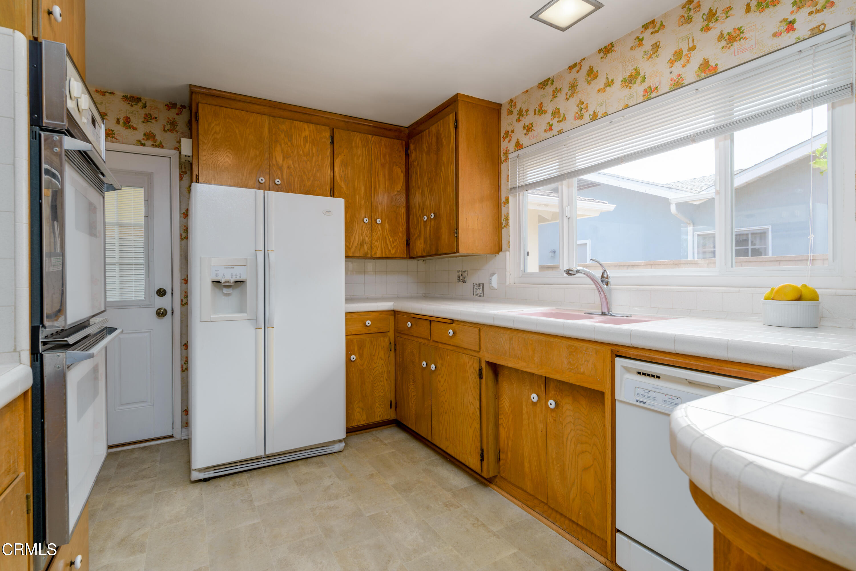 1126 West Roderick Avenue Oxnard, CA 93030 - Photo 8 of 28 a bathroom with a sink and a refrigerator