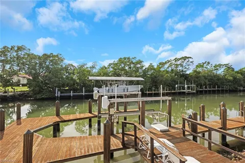 a view of a lake with a table and chairs