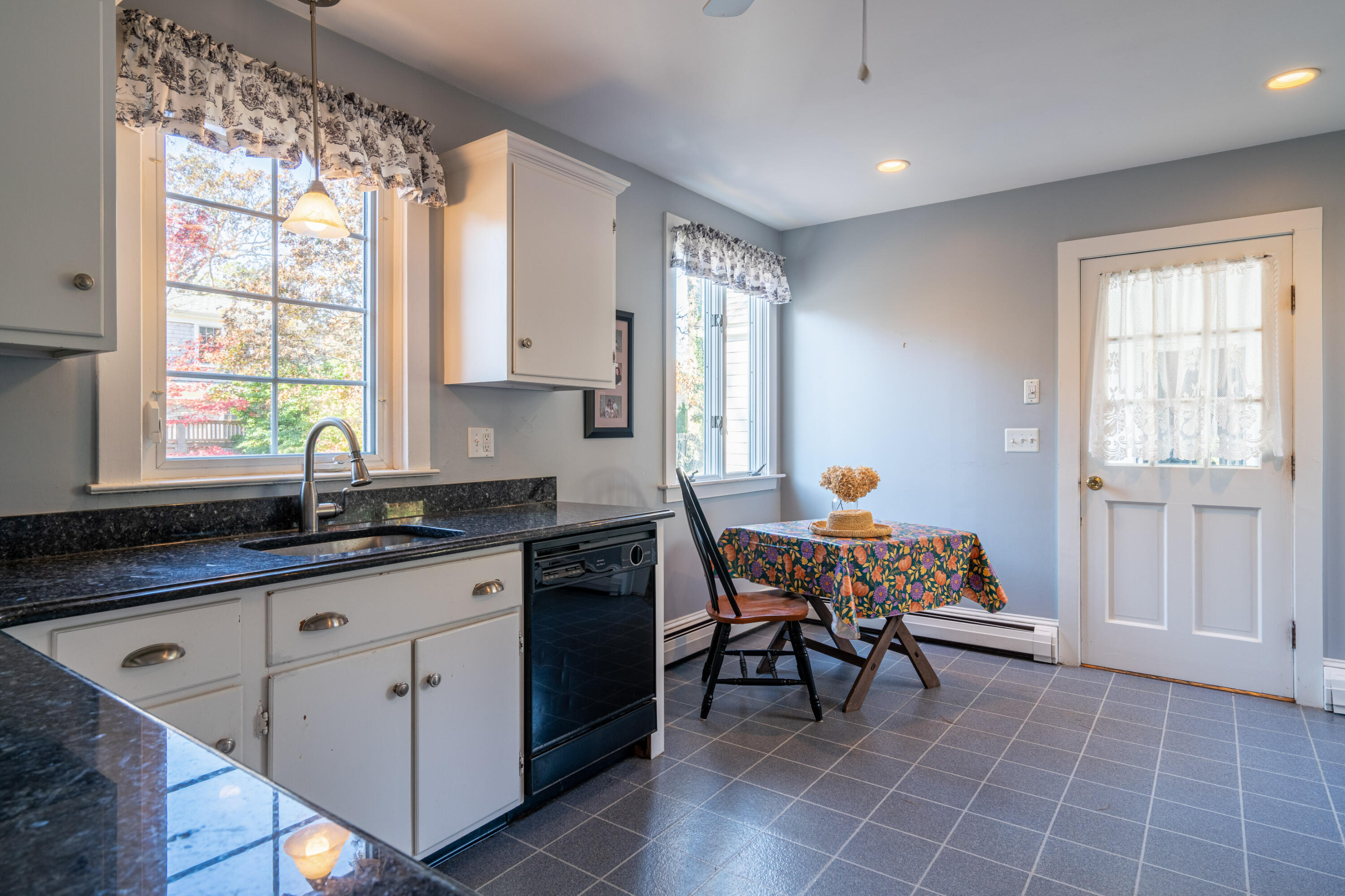69 Blanid Road Osterville, MA 02655 - Photo 8 of 27 a kitchen with a sink a table and chairs in it