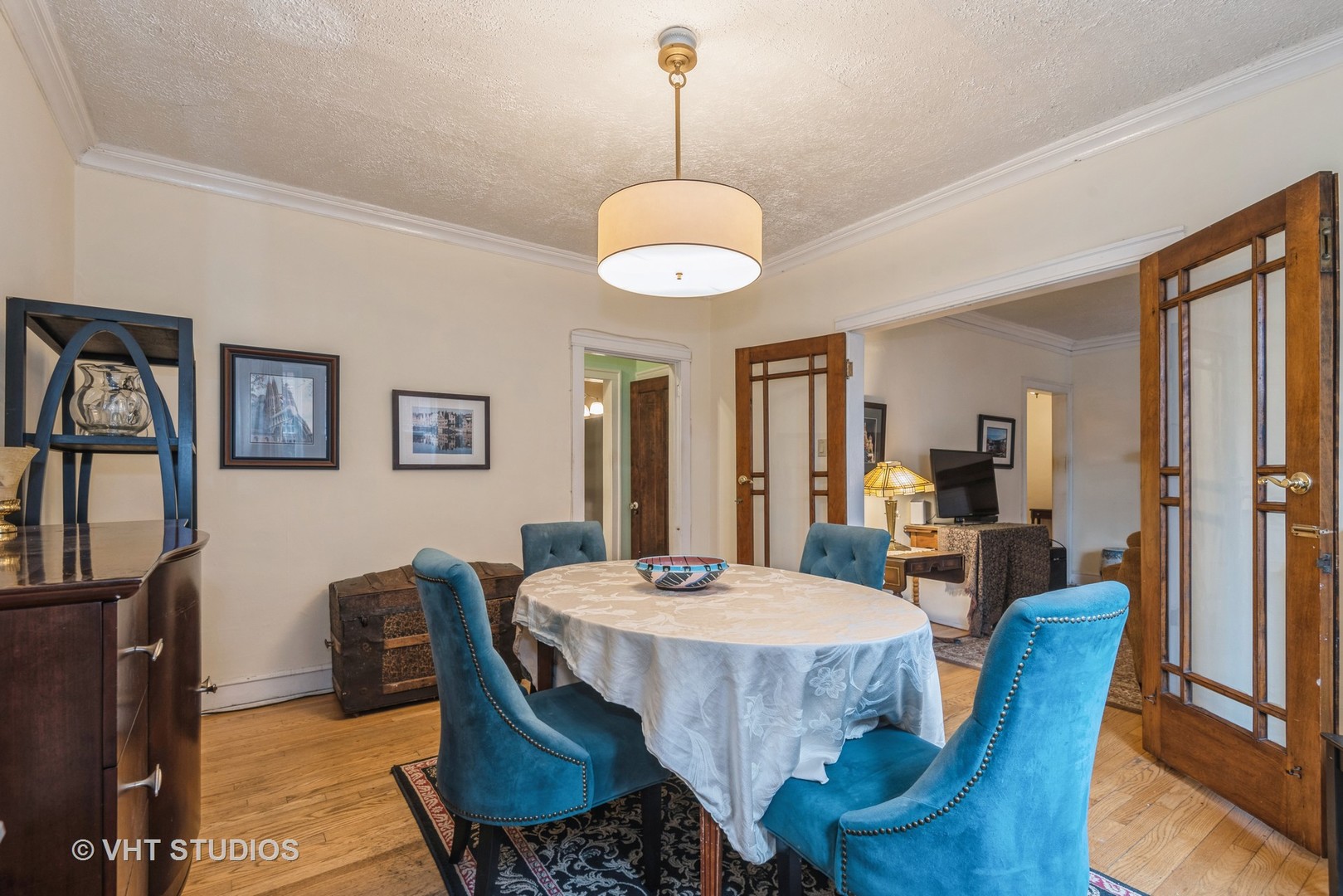 528 Sheridan Road, Unit 1A Evanston, IL 60202 - Photo 7 of 10 a dining room with furniture a chandelier and wooden floor