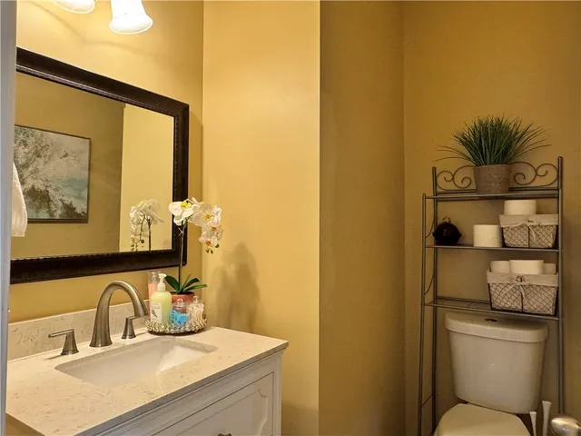 a bathroom with a sink mirror and vanity