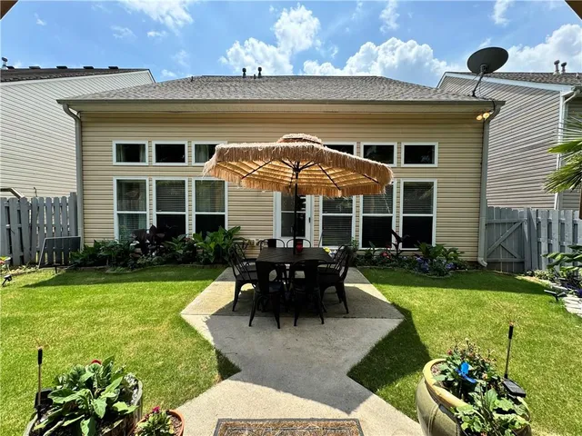 a view of a house with backyard sitting area and garden