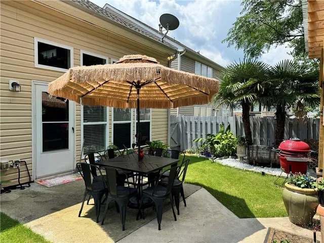 a view of a table and chairs in backyard of the house