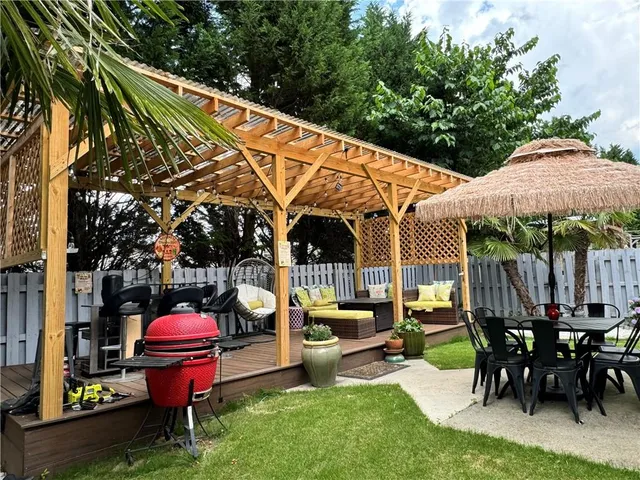 a patio with a table and chairs under an umbrella