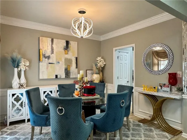 a dining room with furniture a mirror and wooden floor