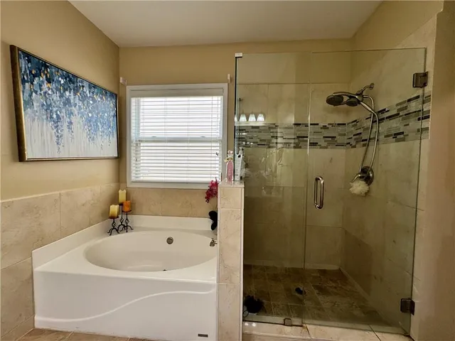 a bathroom with a sink a window and a shower