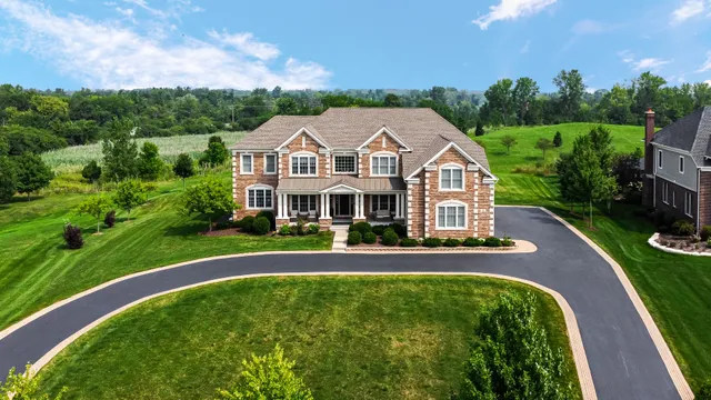 a front view of a house with a yard table and chairs