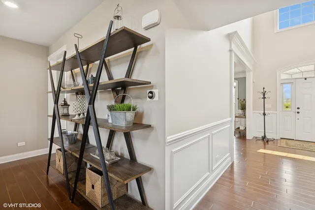 a bedroom with a bed chandelier and a window