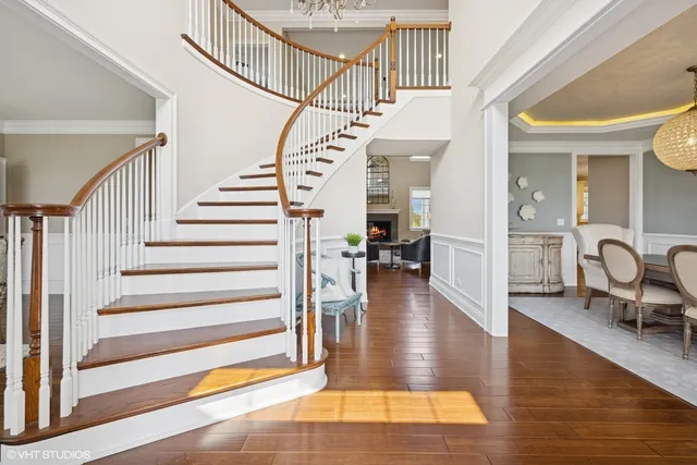 a view of entryway and hall with wooden floor