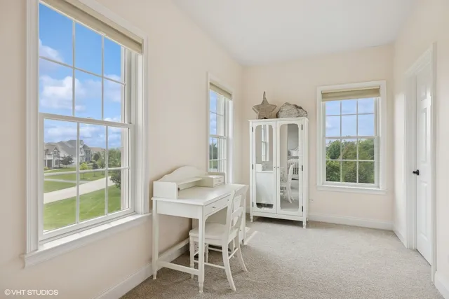 a kitchen with stainless steel appliances kitchen island granite countertop a table chairs and wooden floor