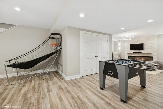 an aerial view of a house with outdoor space and trees all around