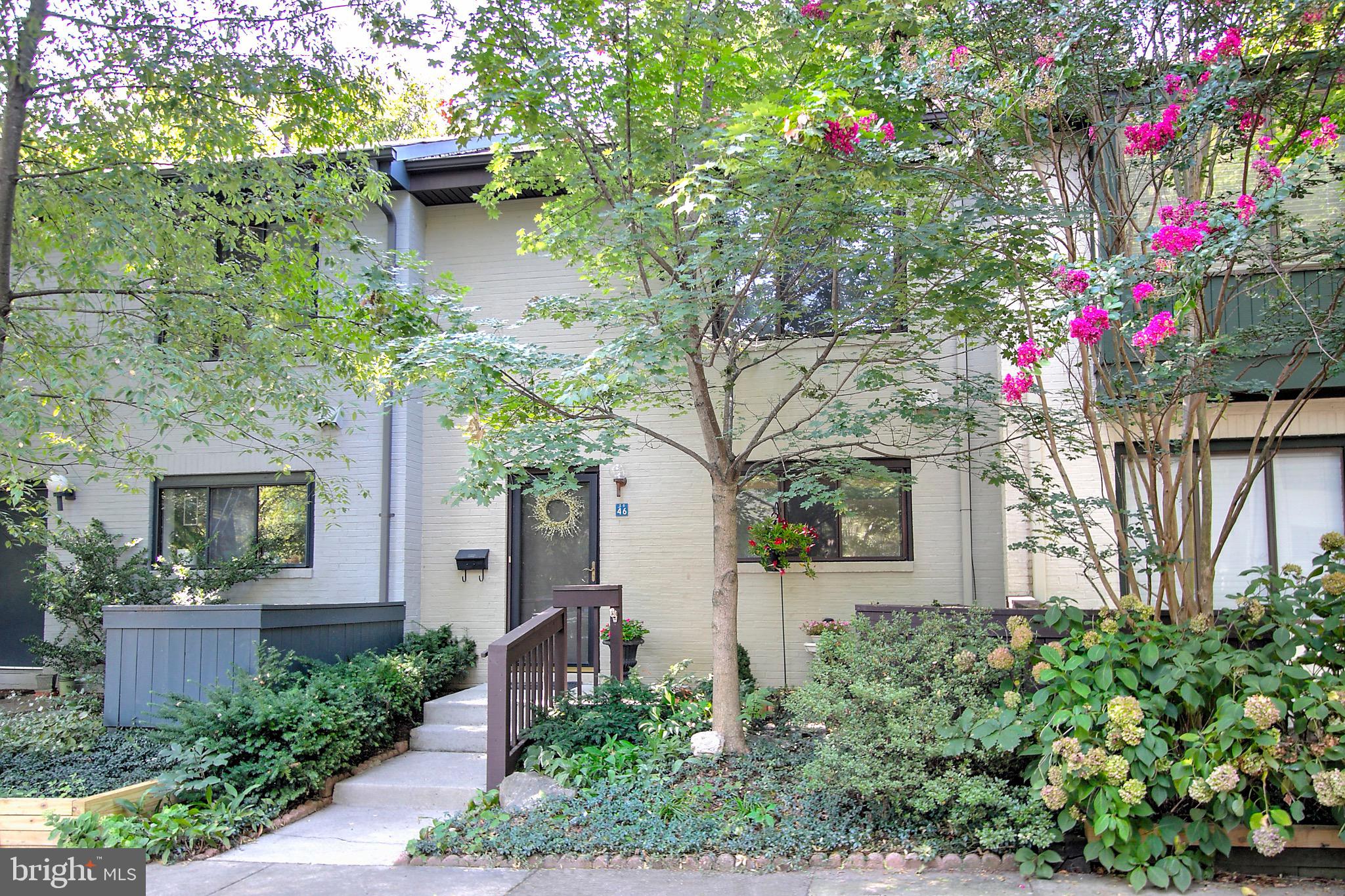 a flower garden is sitting in front of house