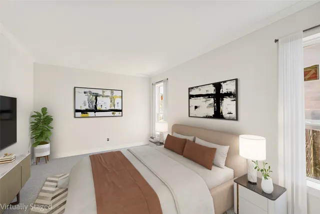 a bedroom with a large bed and a painting on the wall