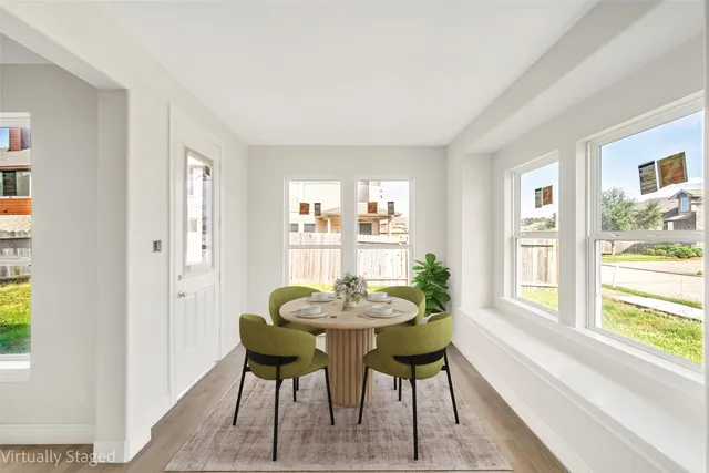 a dining room with furniture and window