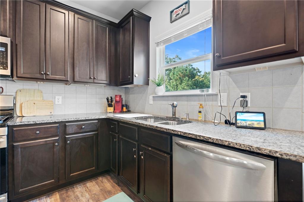 511 A Autumn Echo Canton, GA 30114 - Photo 11 of 39 a kitchen with stainless steel appliances granite countertop a sink stove and cabinets