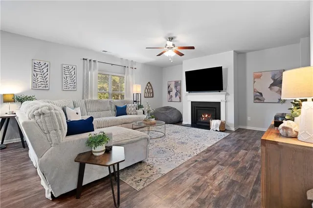 a living room with a fireplace and a flat screen tv