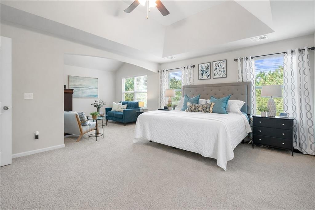 511 A Autumn Echo Canton, GA 30114 - Photo 15 of 39 a bedroom with bed and a chandelier