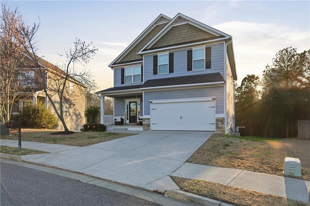 511 A Autumn Echo Canton, GA 30114 - Photo 2 of 39 a front view of a house with a yard and garage