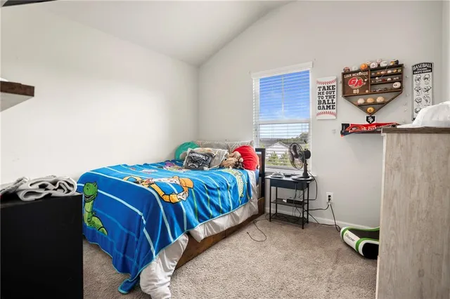 a living room with baby crib furniture and a flat screen tv