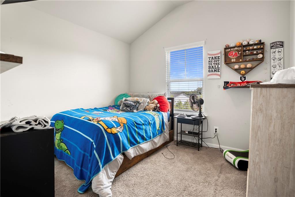 511 A Autumn Echo Canton, GA 30114 - Photo 22 of 39 a bedroom with a bed and cabinets