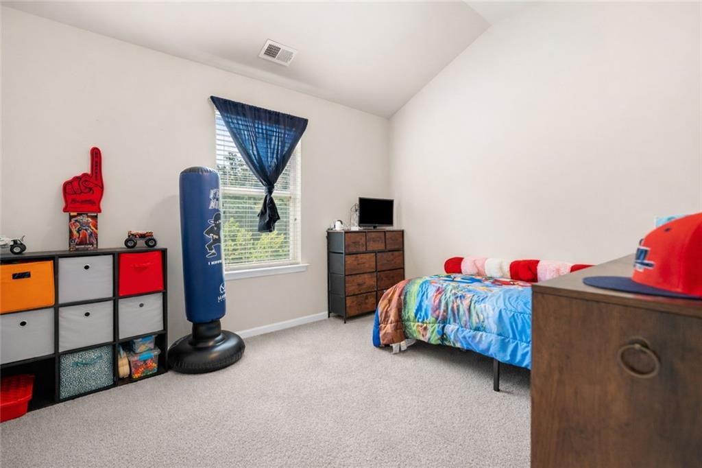 511 A Autumn Echo Canton, GA 30114 - Photo 23 of 39 a living room with baby crib furniture and a flat screen tv