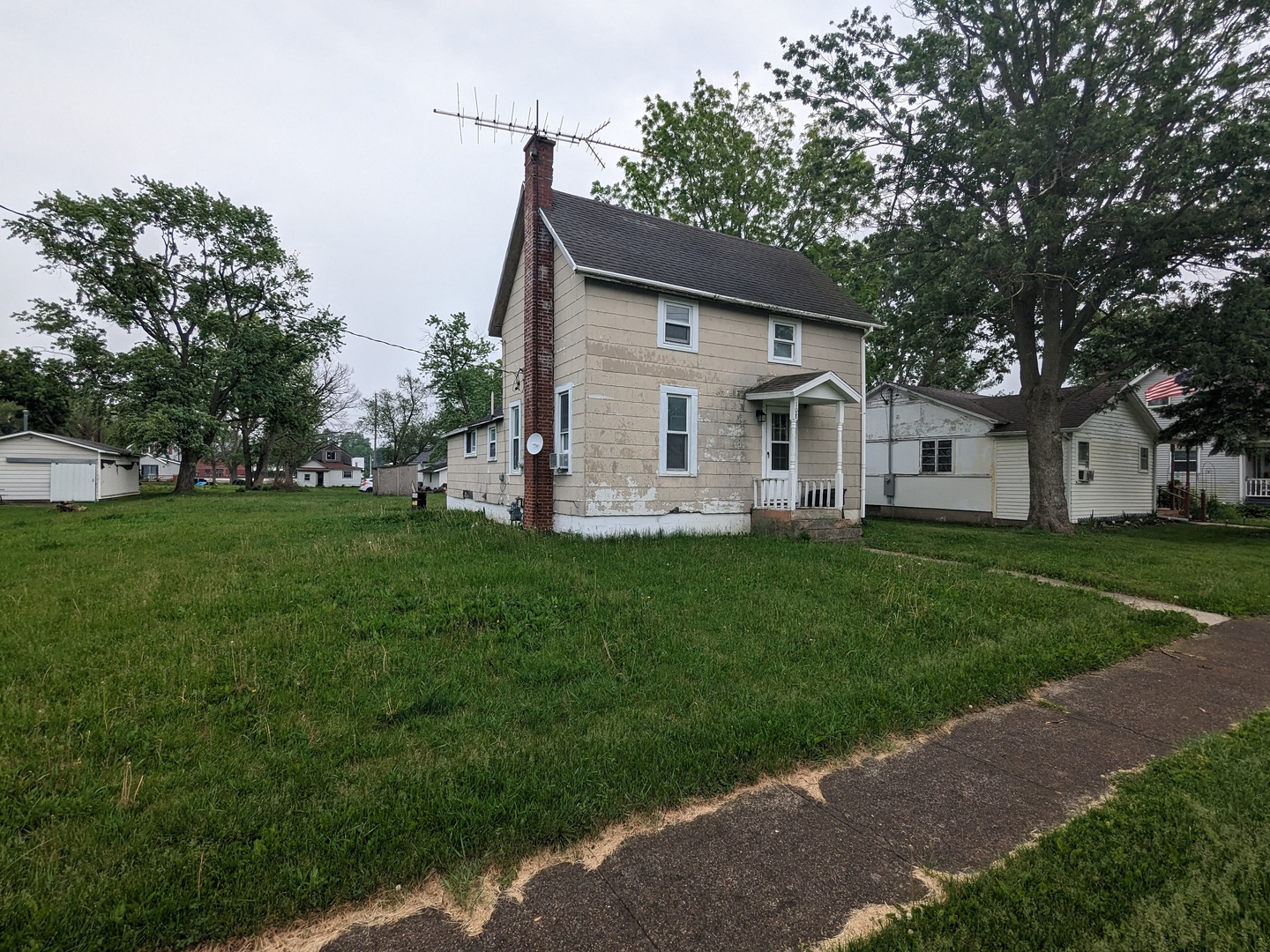 108 3rd Street Buckley, IL 60918 - Photo 2 of 23 a front view of house with a garden and trees
