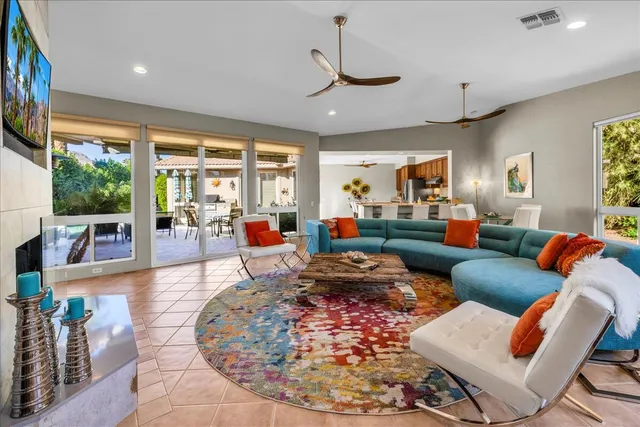 a living room with furniture large window and a table