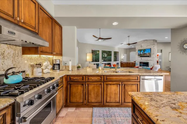 a kitchen with stainless steel appliances granite countertop a stove and a sink