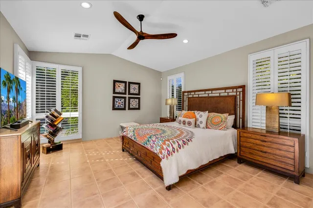 a bedroom with a bed and a large window