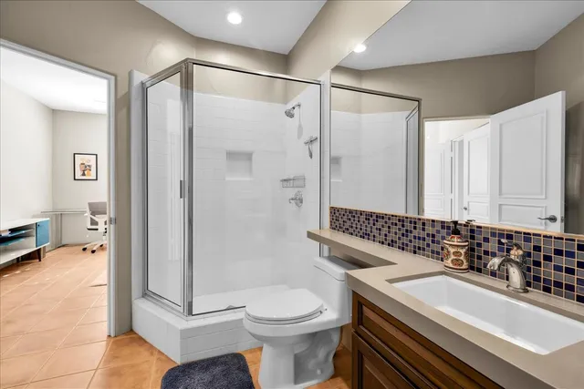 a bathroom with a sink toilet and shower