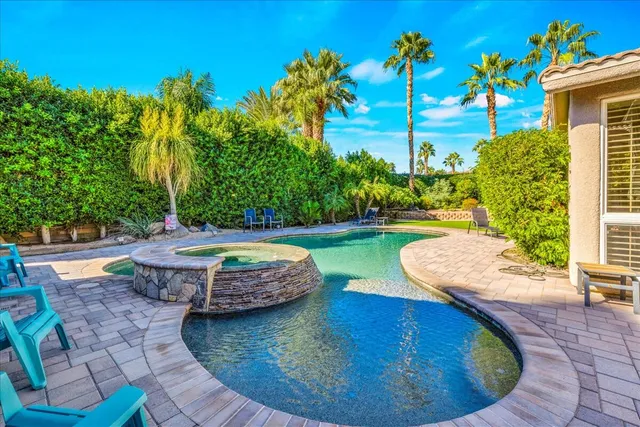 a view of a swimming pool with lounge chair