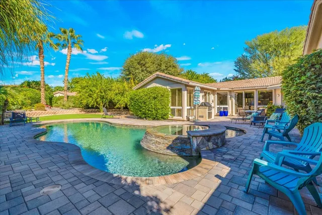 a view of a house with backyard porch and sitting area