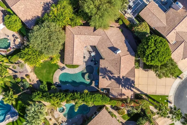 an aerial view of a house with a yard and garden