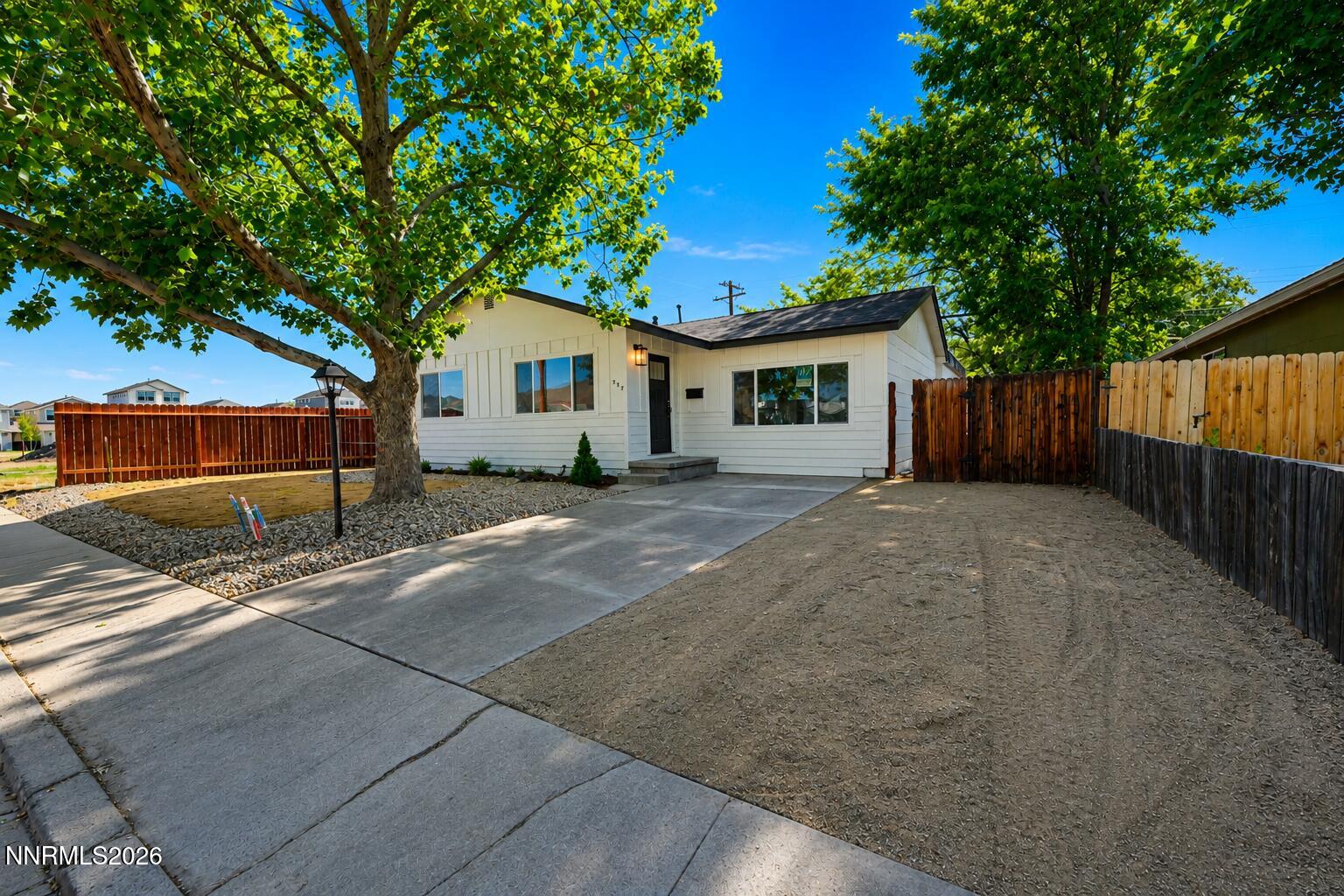 742 Ruth Street Carson City, NV 89701 - Photo 2 of 25 a view of a house with wooden fence next to a yard