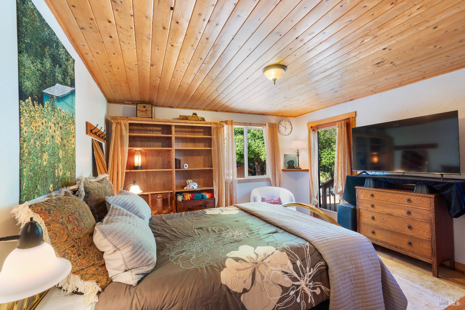 13635 Denmark Creek Road Boonville, CA 95415 - Photo 15 of 75 a bed room with a bed television and a large window