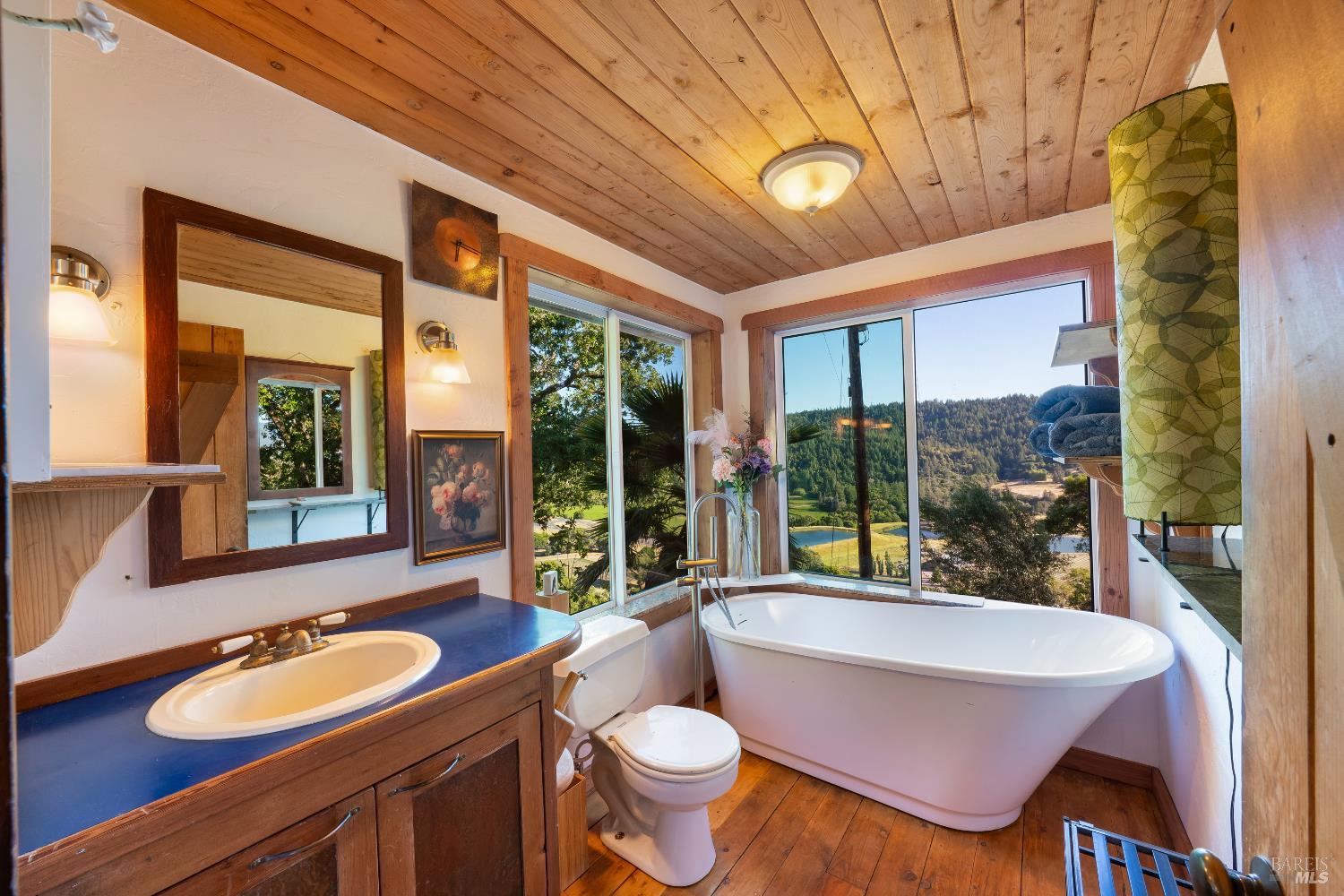 13635 Denmark Creek Road Boonville, CA 95415 - Photo 26 of 75 a bathroom with a granite countertop sink and a large mirror