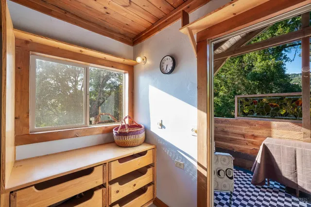 a view of an entryway with wooden floor and door