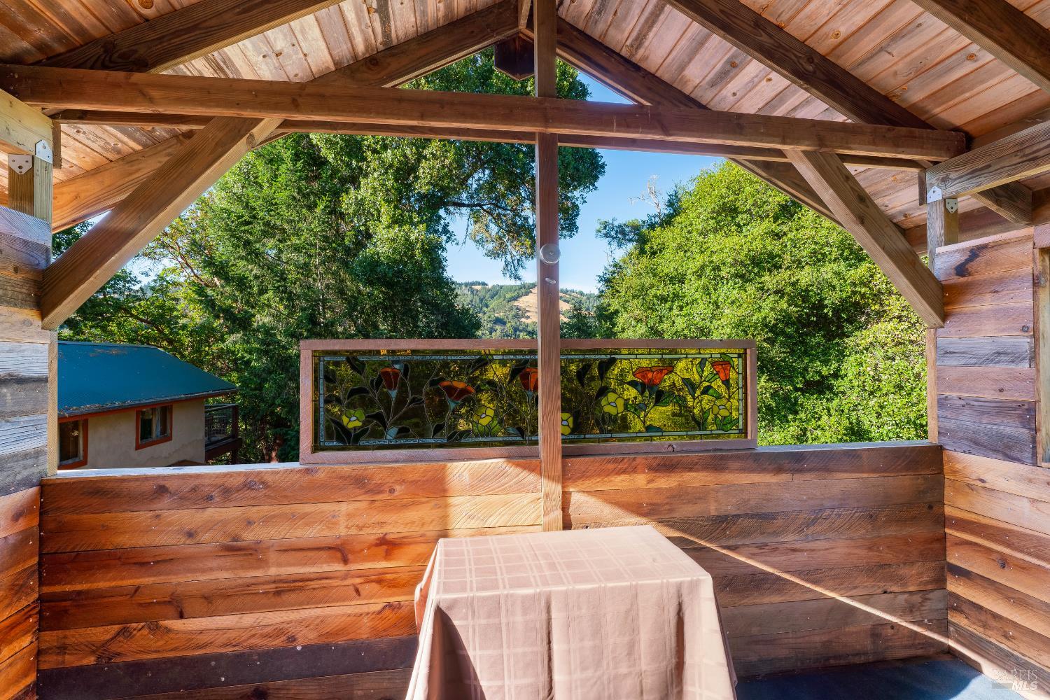 13635 Denmark Creek Road Boonville, CA 95415 - Photo 30 of 75 a view of a patio with table and chairs potted plants with wooden floor